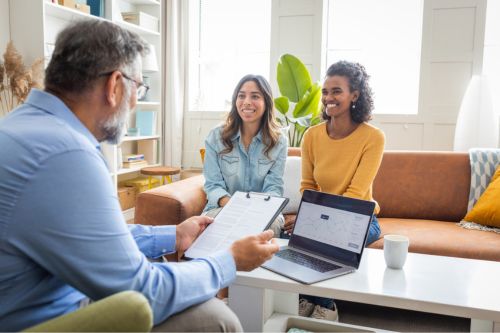 A real estate agent advises his clients, a female interracial gay couple, about common buying and selling mistakes in real estate.