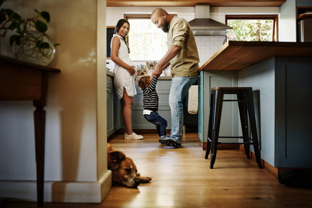 A family and their dog spend time in the kitchen.