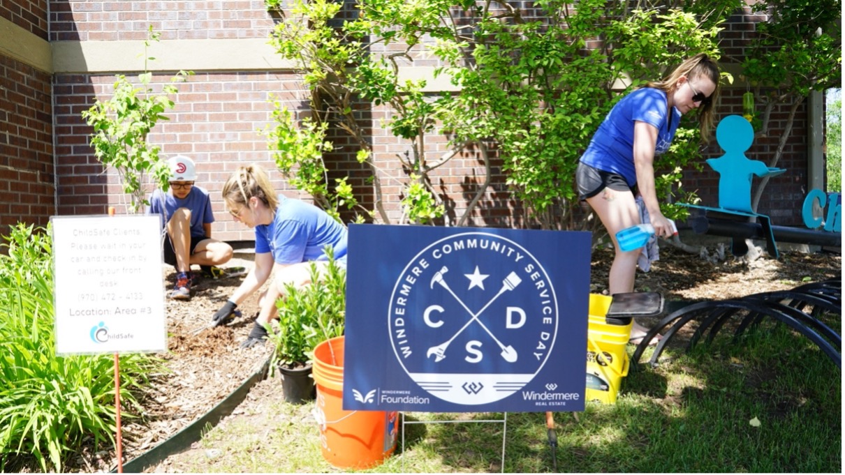 Two women and a boy work in the garden.