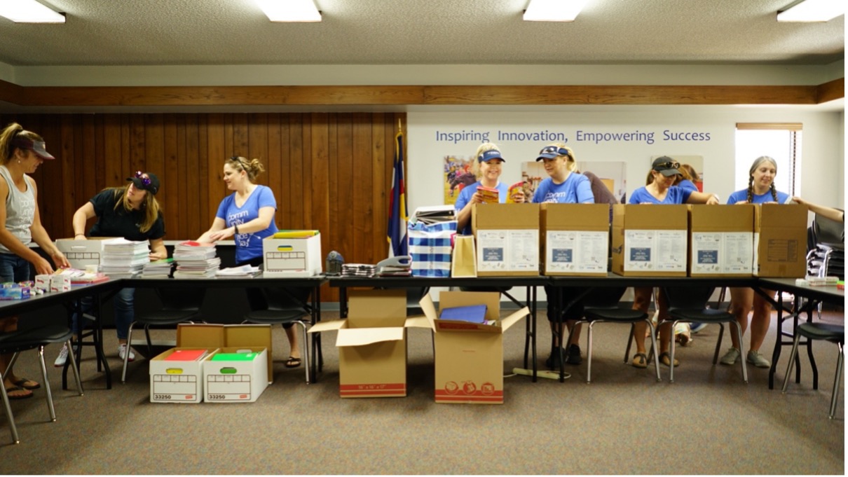 A group of women handle drop box donations.