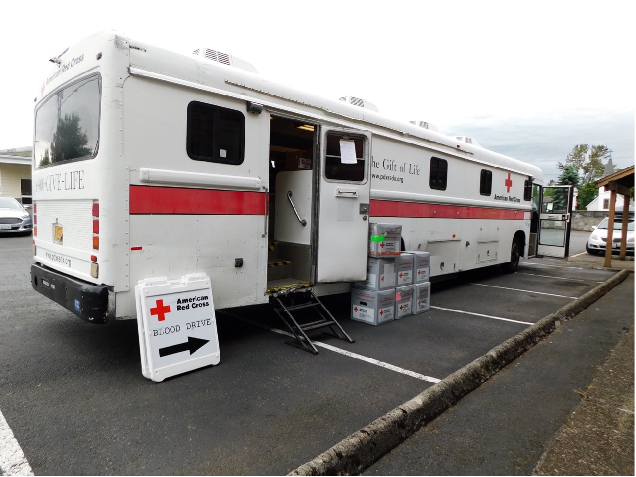 A white American Red Cross truck parked in a parking lot.