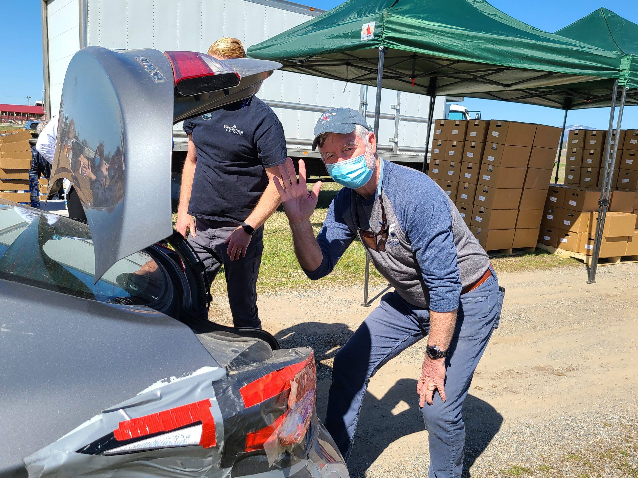 A man unpacks boxes during a food drive. 