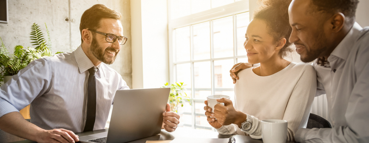 A man and a woman discuss selling their home with their Windermere real estate agent.