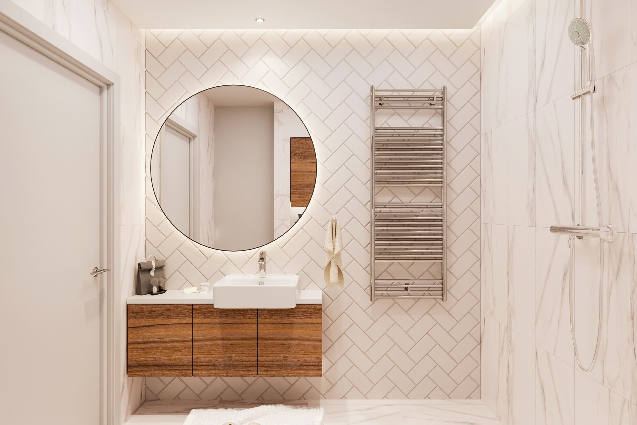 A bathroom wall decorated with herringbone tile behind the vanity and mirror. 