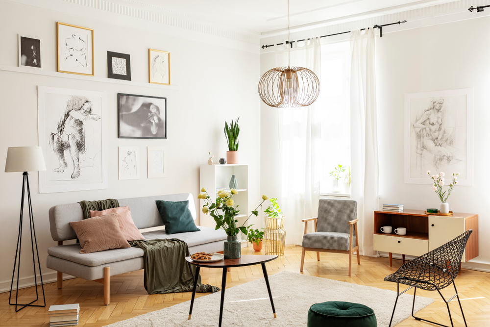 A living room with a gallery wall behind a couch. 