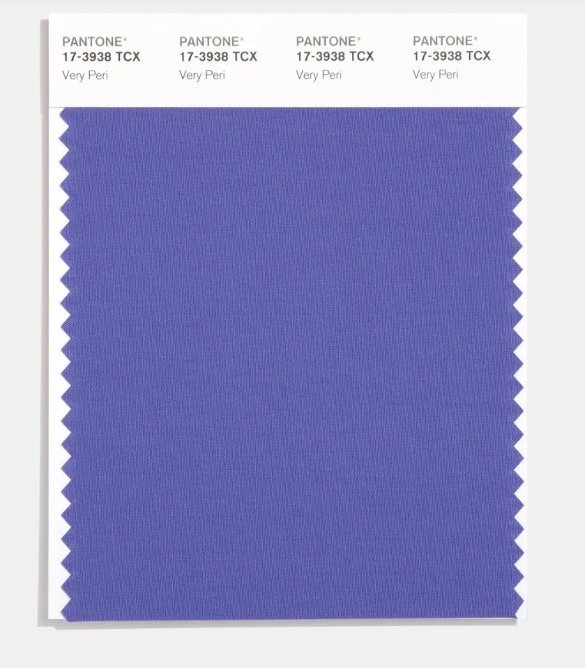 A swatch card showing Pantone’s color of the year 2022: Very Peri, which is a periwinkle blue with a violet-red undertone.