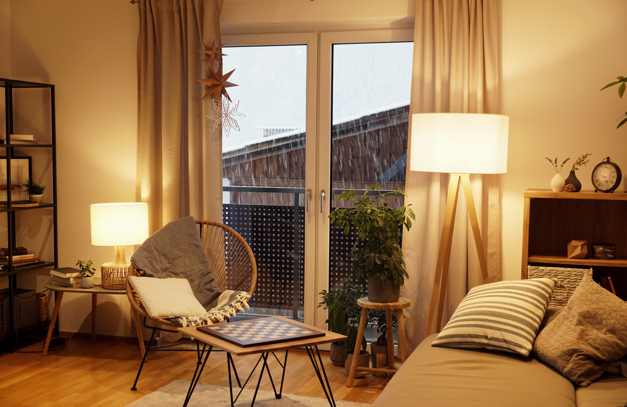 A bedroom with a floor lamp and a lamp on a nightstand.