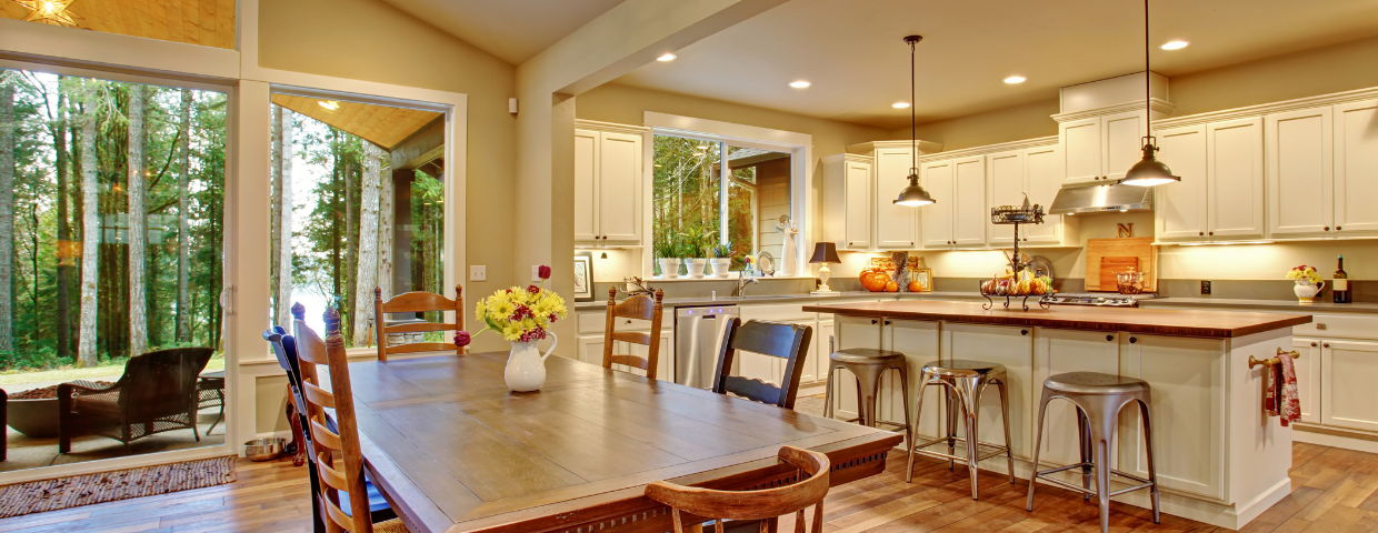 A well-lit open kitchen and dining room area.