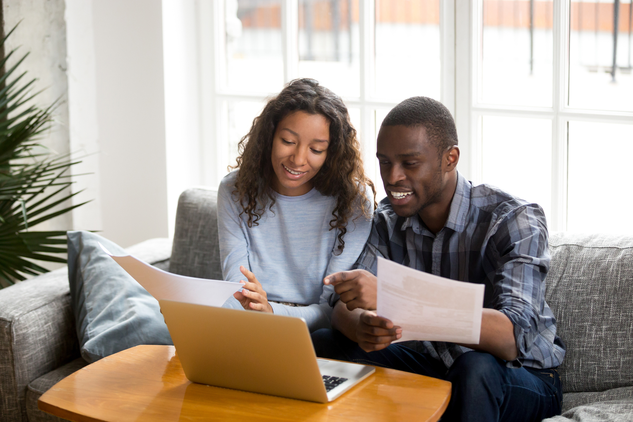 A man and a woman review their real estate contingency paperwork for the sale of their home.