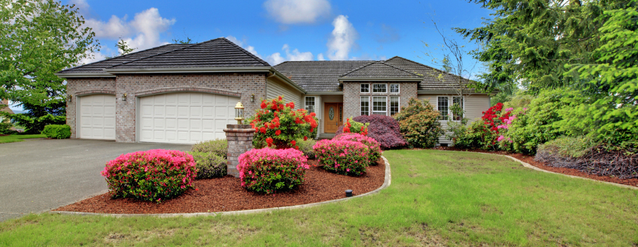A freshly landscaped suburban home with multicolored shrubbery.