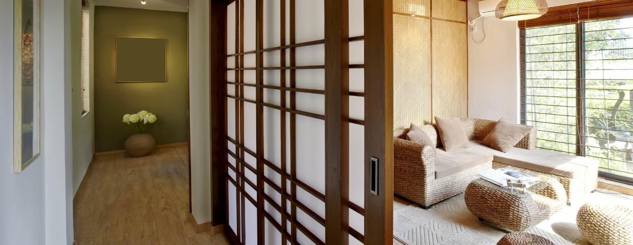 A room and hallway separated by a sliding Japanese garden door.
