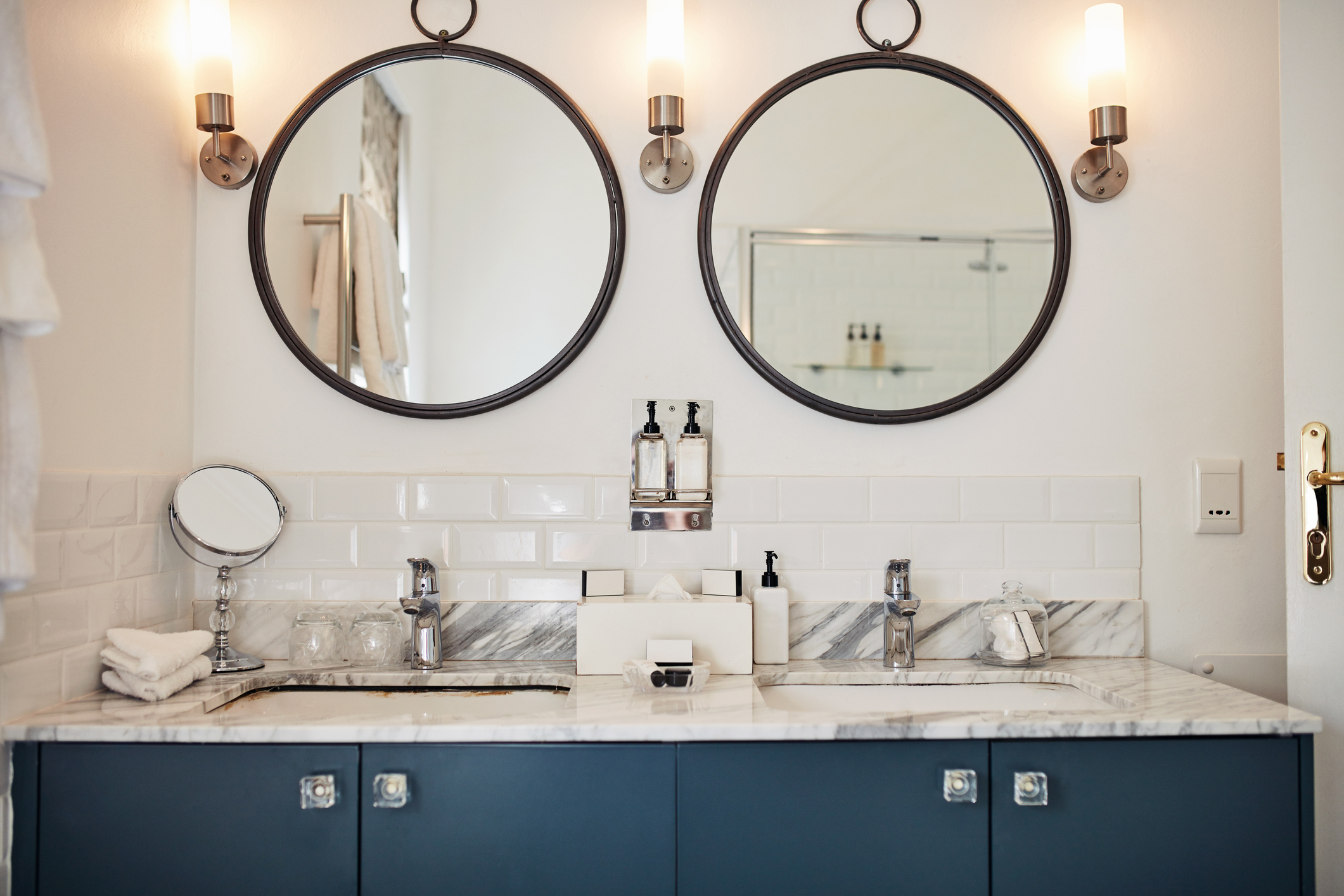 A modern bathroom with a marble backsplash.