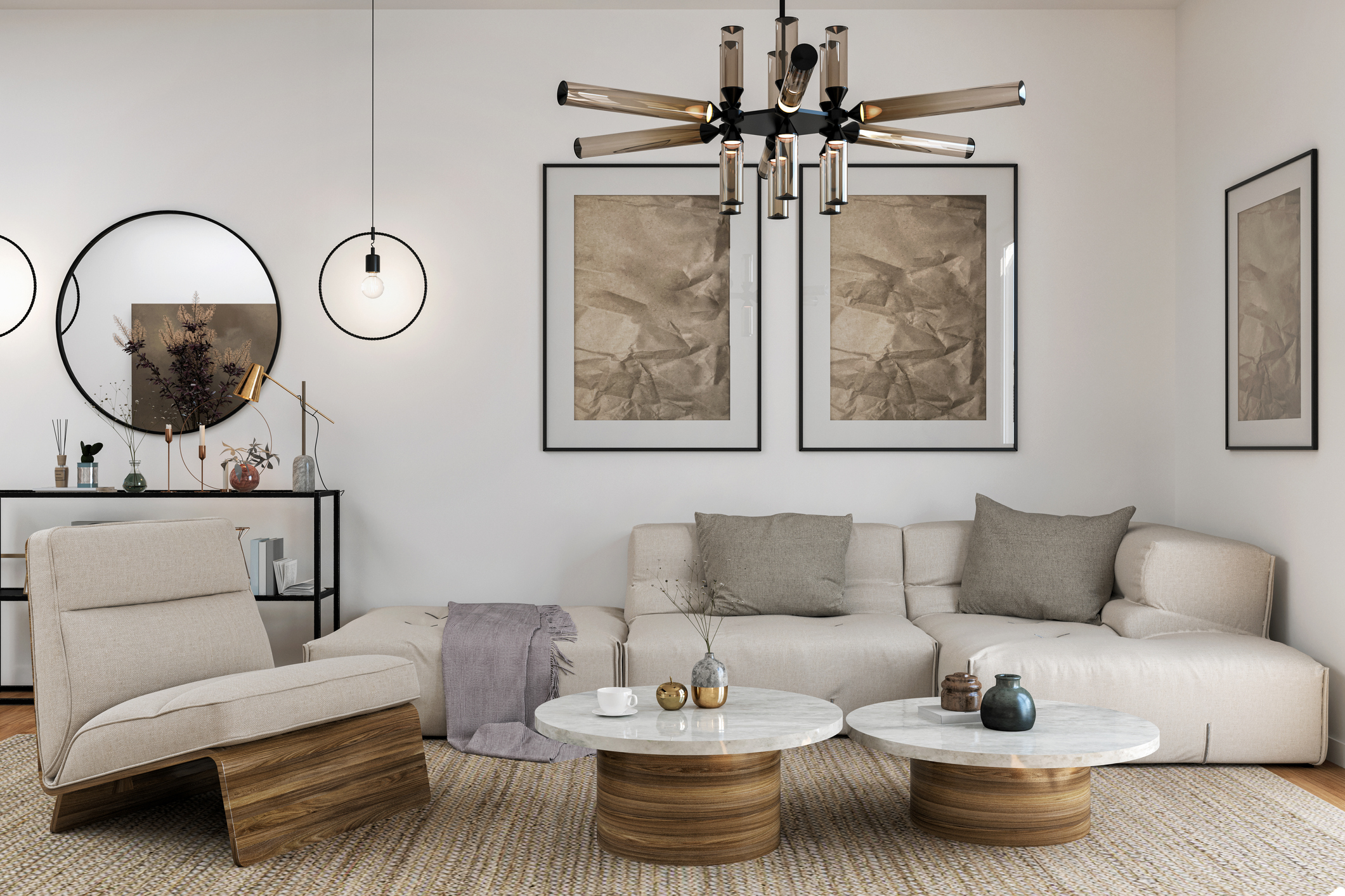 A living room area characterized by a neutral-colored contemporary interior design style. White walls host large neutral art in black frames. An off-white sectional couch with pewter heathered pillows and a grey blanket sit in the corner, with 2 wood and white marble round coffee tables. On the left is an angular seat with matching wood frame and cream-colored cushions. Above is a metal and dark glass light fixture. Open concept is implied with a black metal table in the back on the left against the wall, with metal lamps, glass reed infuser, and metal candle holders.