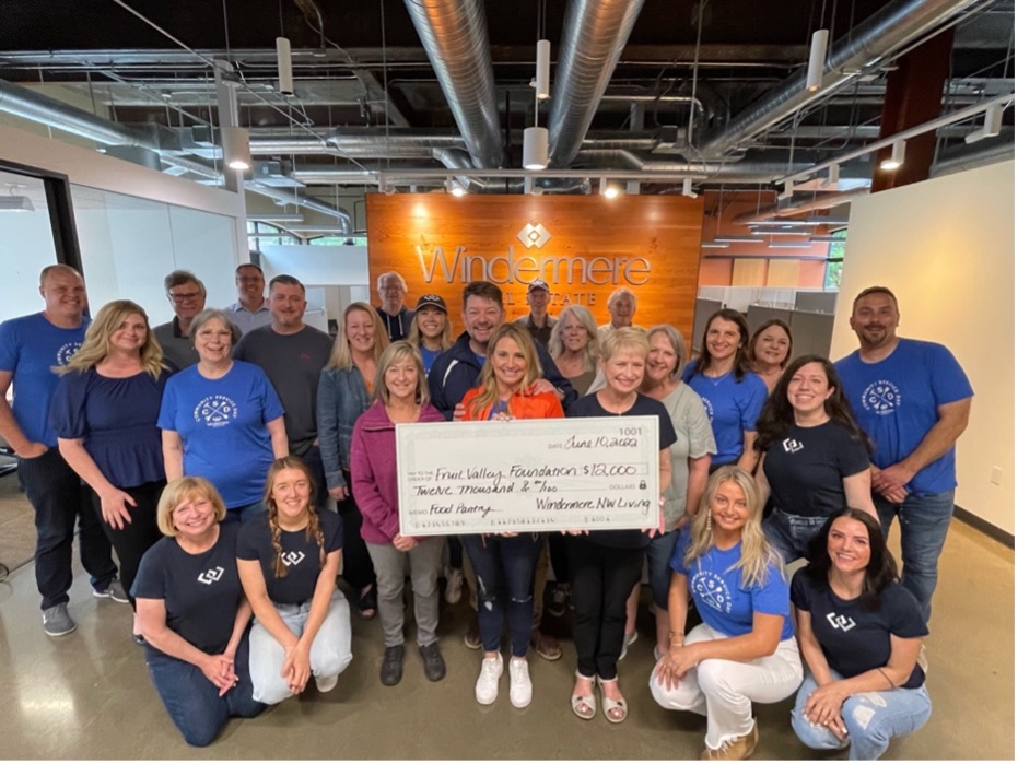 A group of Windermere agents and staff from Northwest Living in Vancouver, WA hold up a check for $12,000.