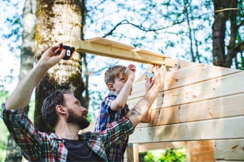 Father and son build a firewood shed in the backyard