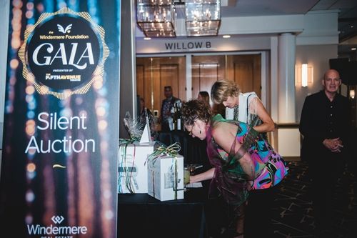 Windermere Foundation Gala attendees bid on a pizza oven in the ballroom foyer of the Grand Sheraton hotel in Seattle, WA