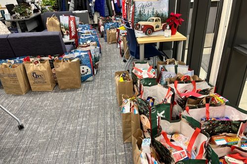Dozens of bags fill the hallway of Lake Grove Elementary school. They are filled with food and gifts to students in need, donated by the agents and staff at the Windermere West Campus and South Sound offices in Federal Way, Washington.