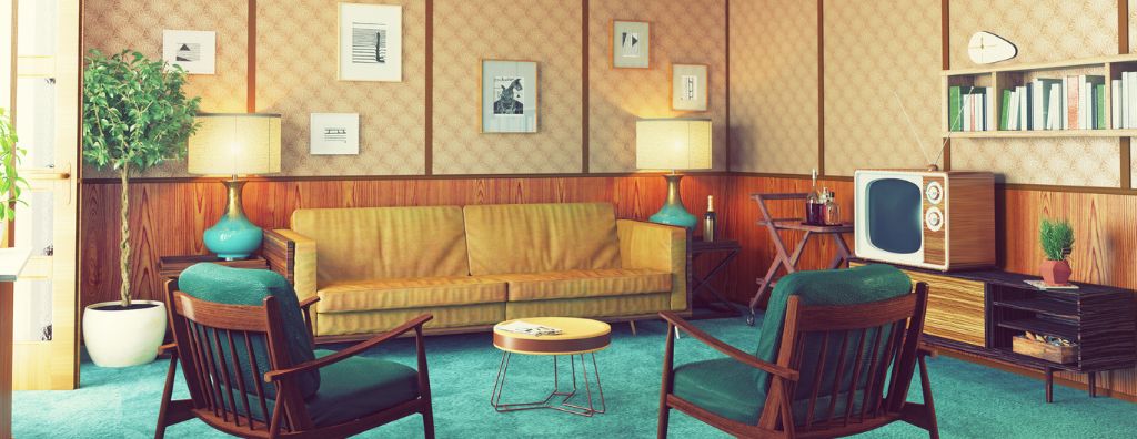 A mid-century modern living room with a retro TV set on top of a credenza, a low mustard colored couch with wood panel sides and wooden peg legs, chairs with an Eames profile and teal cushions, and colorful light blue and gold lamps.