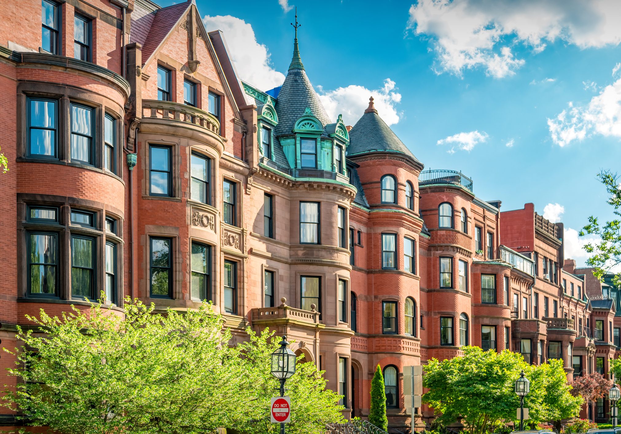 Typical brownstone townhouses in Back Bay district of downtown Boston, Massachusetts, USA on a sunny day.